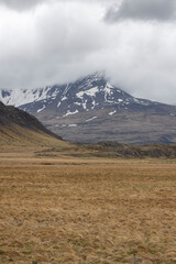 Mountain peak in rural Iceland , covered in clouds