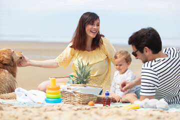 family enjoying the beach with father mother and child