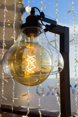 Old style spiral lamp with sky on background