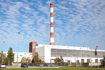 Obraz premium Large, tall electricity thermal power plant red, white color chimney building factory.