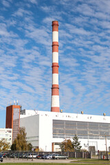 Large, tall electricity thermal power plant red, white color chimney building factory.