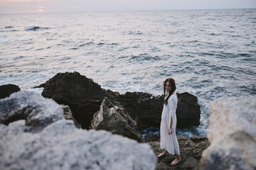 woman traveler walks volcanic rock formations on the island nature