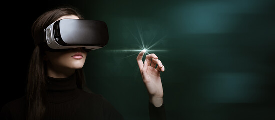 Woman wearing VR goggles and interacting with virtual reality