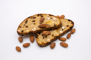 Slices of sweet dessert multigrain bread with nuts and almonds. Healthy diet. Isolated on white background.