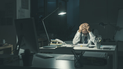 Stressed business executive working overtime