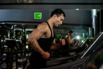 Asian men wear black workout in fitness center