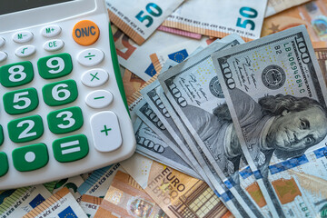 concept of exchange of dollars and euros with calculator