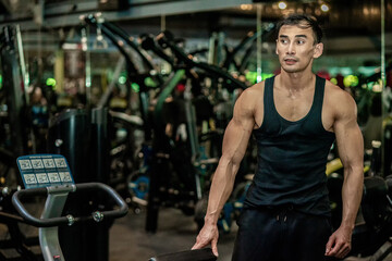 Fototapeta na wymiar Asian men wear black workout in fitness center