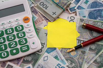beautiful calculation business calculator pen notebook on polish zloty background.