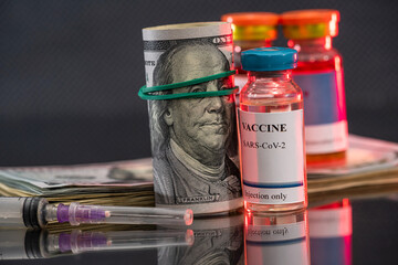 dollars calculator and tested vaccine against the crown of the virus is located on the table.
