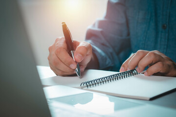 Close-up of Hand using writing pen with questionnaire or paperwork survey question filling in...