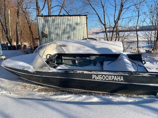 a boat in the winter in the snow with an inscription in Russian - 