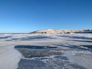 view of the port of the Volga river frozen in ice and covered with snow