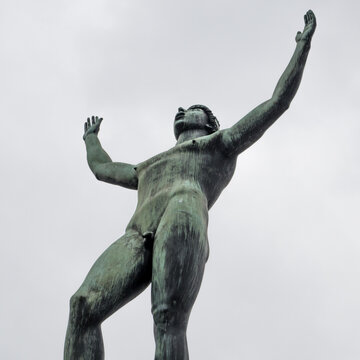 Stockholm, Sweden - 04.15.2017: Detail wide low angle shot of Solsangaren, The Sun Singer, statue against bright sky. Statue in front of the Swedish Parliament.