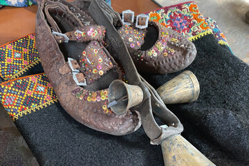 Garage sale in town hall, Tlum and Kram. Ukrainian vintage shoes - traditional hutsul shoes postoly. Secondhand goods on flea market, thrift shopping concept. Selective focus