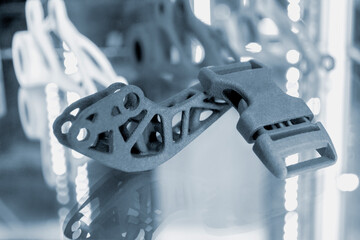 Black model clip clasp and abstract object printed on 3d printer from powder close-up. 3D prototype...