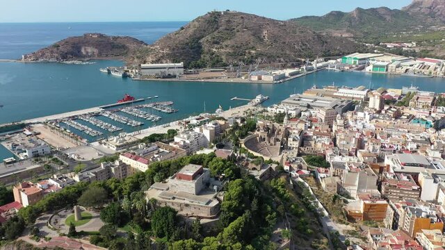 Aerial view of Cartagena port city with buildings and coast line, Autonomous Community of Murcia, southeastern Spain. High quality 4k footage