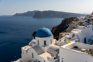 Oia, Greece - July 30, 2021: View of the church St. Anastasi and St. Spirydon in Oia