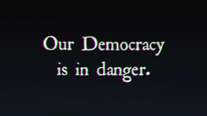 An ominous text message, written with an old typewriter, shaken by intentional glitch and distortion fx: Our Democracy is in danger.
