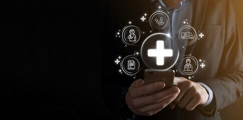 Businessman hold virtual plus medical network connection icons. Covid-19 pandemic develop people awareness and spread attention on their healthcare.Doctor,document,medicine,ambulance,patient icon.