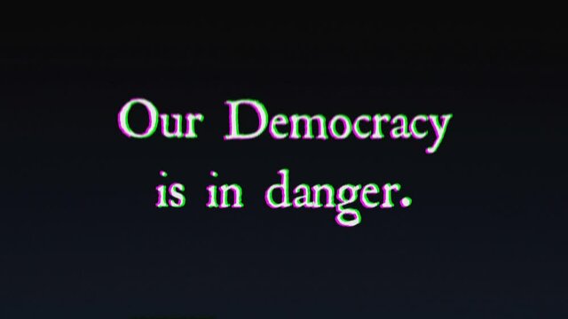 An ominous text message, written with an old typewriter, shaken by intentional glitch and distortion fx: Our Democracy is in danger.
