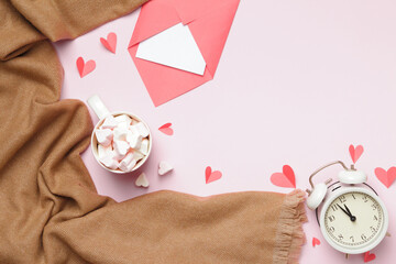 Beige cashmere scarf marshmallow cup alarm clock envelope with a note on a pink background....