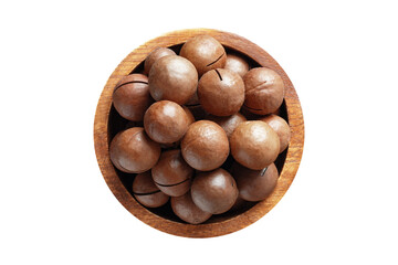 shelled macadamia nuts in wooden bowl isolated on white background. Vegan food, top view.