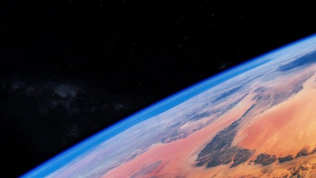 Flying over Murzuch desert, Libya, view from space station orbiting planet earth, sky stars in background. Based on image by Nasa
