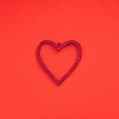 Red shining heart as decoration on red background