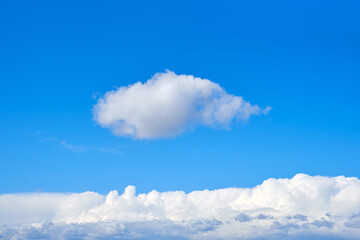 Naklejka na ściany i meble Blue sky with a single white cloud, copy space for text