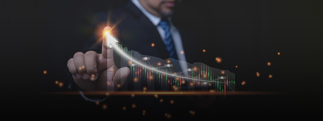 Businessman touching to pointing arrow graph growth, and financial network online connection. Analyzing data profit to achieve business investment goals in the future. Business, Technology concept.