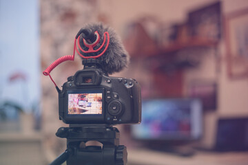 Digital camera with a microphone windshield in the room. Blogging equipment. Soft focus retro colors