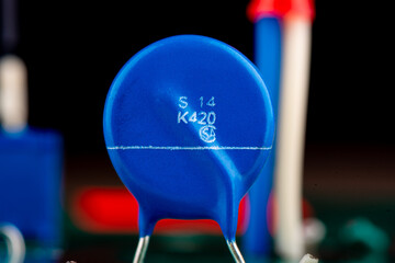 Close up of blue varistor electronic circuit board element.