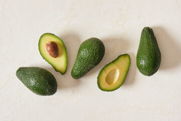 fresh whole and sliced avodcado fruit on light background