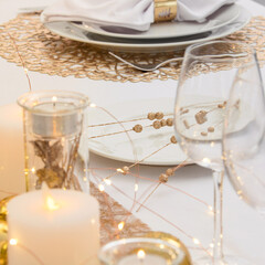Beautiful table setting with Christmas decorations. Gold colors