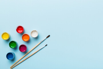 art palette with paint and brushes, close up. Top view with empty space. workplace for creativity. home teaching concept drawing