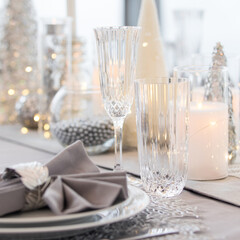 Beautiful table setting with Christmas decorations. Silver colors