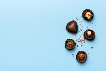 Different kinds of chocolates on colored table close-up. Top View and Flat Lay with copy space