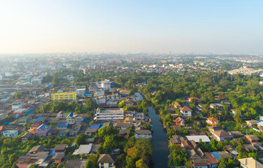 Aerial view of Bang Khun Thian Canal with nature trees, Wutthakat district, Bangkok City, Thailand in urban city in Asia. Residential houses, buildings at noon.