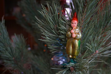 Vintage old 1970s glass Christmas toy of the soviet period boy with a pipe on pine branches...