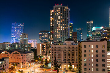 Illuminated cityscape of Los Angeles downtown at summer night time, California, USA. Skyscrapers of...