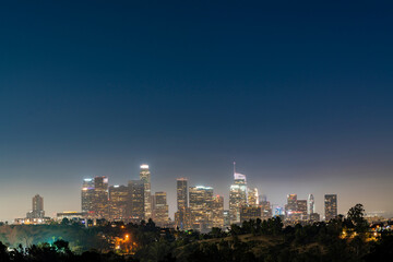 Fototapeta na wymiar Illuminated Skyline of Los Angeles downtown at summer night time, California, USA. Skyscrapers of panoramic city center of LA.