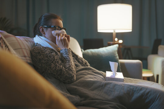 Sick woman with cold resting at home