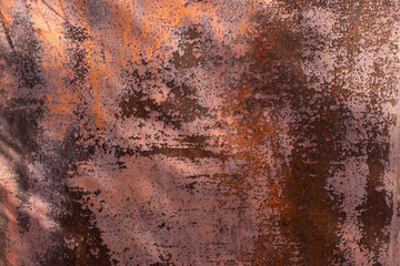 Rusty metal background. Red metal texture with rust. Rust stains a lot and Sun rays, noisy background.