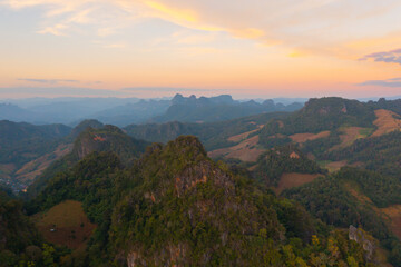 Naklejka premium Aerial top view of forest trees and green mountain hills. Nature landscape background, Thailand.