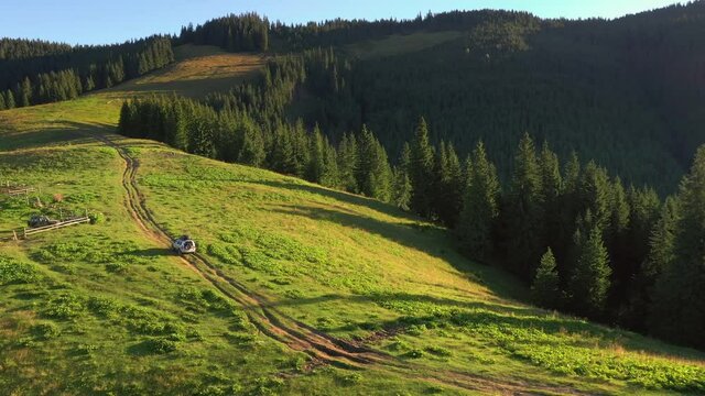 SUV car goes off-road upwards. Auto moving on the mountain road. Location place Carpathian mountains, Ukraine, Europe. 
