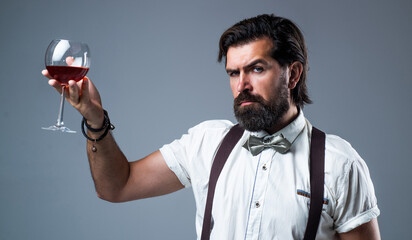 sommelier tasting alcohol. bartender. stylish male barman. drinking wine glass. bearded man in...
