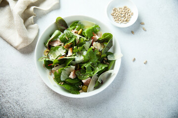 Fresh green salad with olives, bacon and cheese