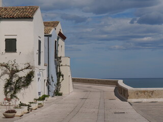 Montecastello street with colorful buildings and the sea in the background along the city walls the Swabian Castle in Termoli