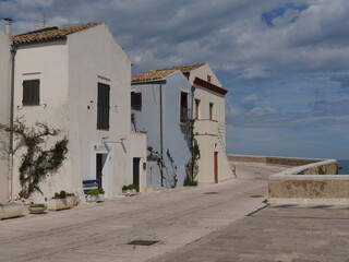 Montecastello street with colorful buildings and the sea in the background along the city walls the Swabian Castle in Termoli